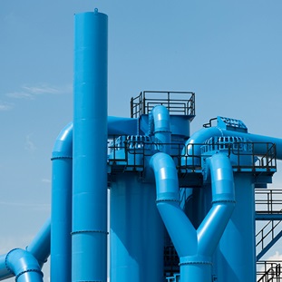 exterior shot of industrial facilitys blue pipes