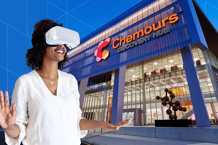 Woman wearing VR headset outside of a Chemours building
